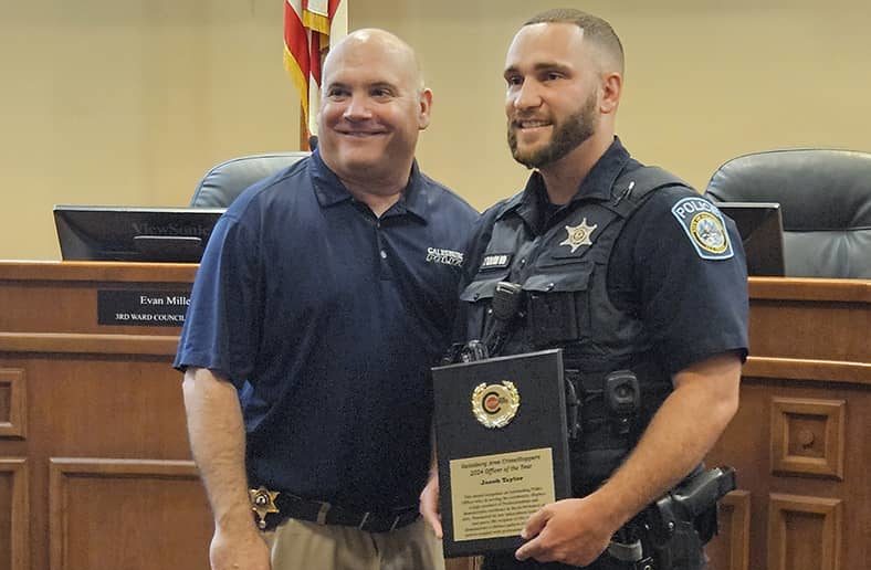 Galesburg Police Department Officer Jake Taylor, right, receives the 2023 Galesburg Area Crime Stoppers Officer of the Year award from GPD Chief Russ Idle.