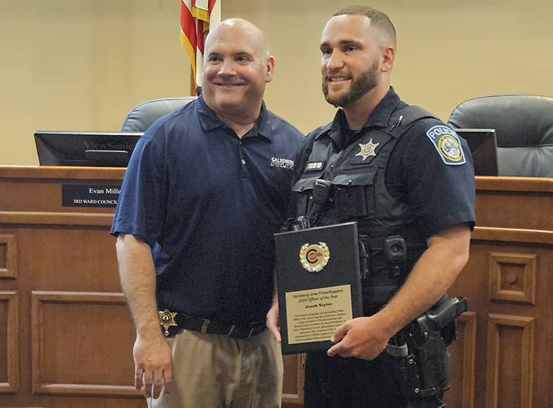 Galesburg Police Department Officer Jake Taylor, right, receives the 2023 Galesburg Area Crime Stoppers Officer of the Year award from GPD Chief Russ Idle.