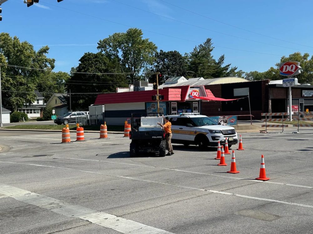 McDonough County Emergency Management officials offer water to an Illinois State Trooper blocking the intersection of Jackson and Ward in Macomb Thursday morning, as a police standoff with a man who allegedly shot two police officers continued. (WILL STEVENSON/WGIL)