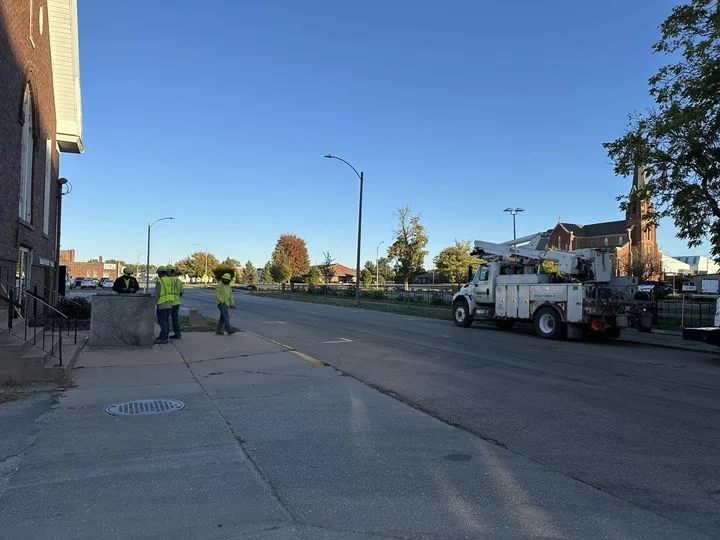 Ameren Illinois crews work on a below-ground transformer Wednesday afternoon near Allen Chapel AME Church in Galesburg. (WILL STEVENSON/WGIL)