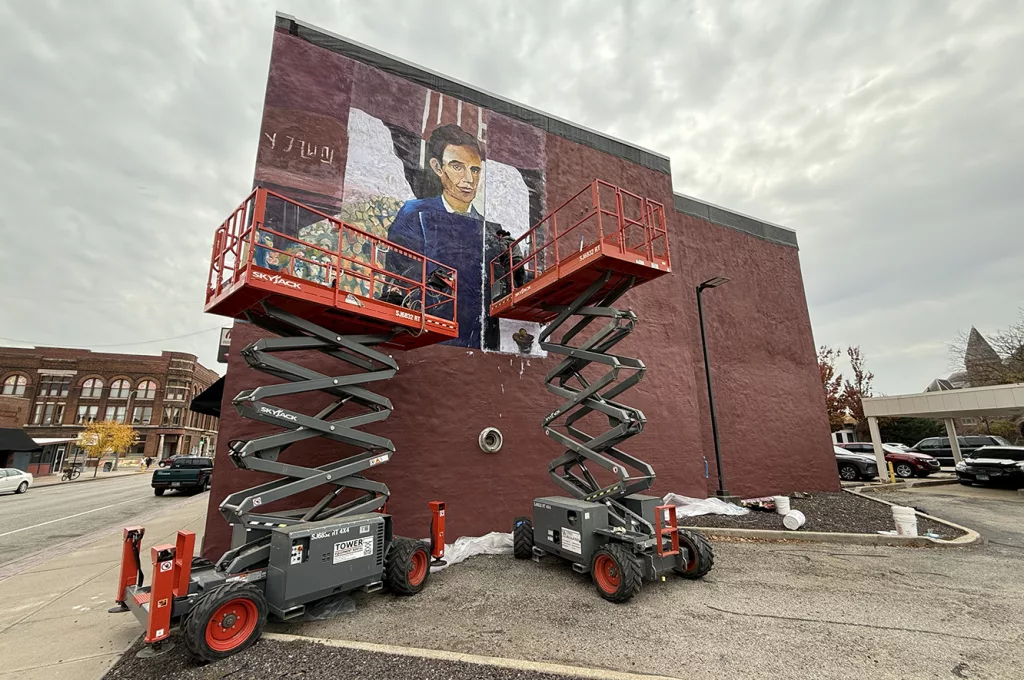 Artist Angie Smith and her assistant Adam Smith work on a 20 by 32 foot mural depicting Abraham Lincoln and his 1858 appearance at Knox College for the Lincoln-Douglas Debate on Monday on the north wall Masa Sushi & Hibachi, 58 S. Cherry St.