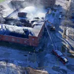 galesburg-fire-cherry-1: Galesburg Firefighters responded to a structure fire at 179 N. Cherry St. at approximately 3:18 a.m. Thursday. Upon arrival, heavy flames could be seen at the structure. (Drone photo Kyle Martin)