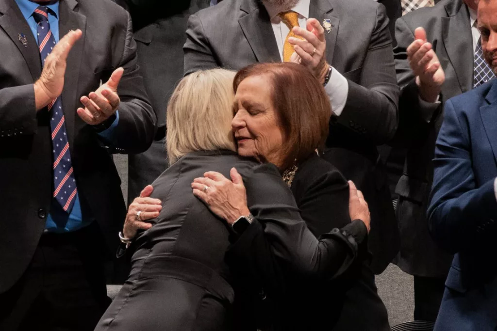 Rep. Norine Hammond, R-Macomb, embraces House Minority Leader Tony McCombie, R-Savanna.