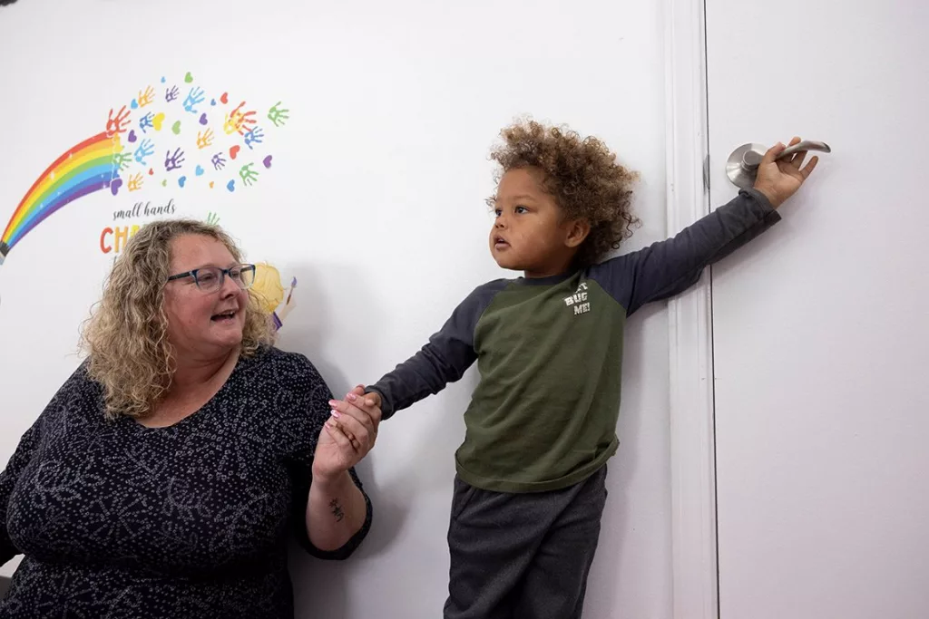 Heather Casner with Raydyan Taylor, 2, at Our World of Learning Child Development Center. Casner and her husband started the day care center in rural Anna, Illinois.