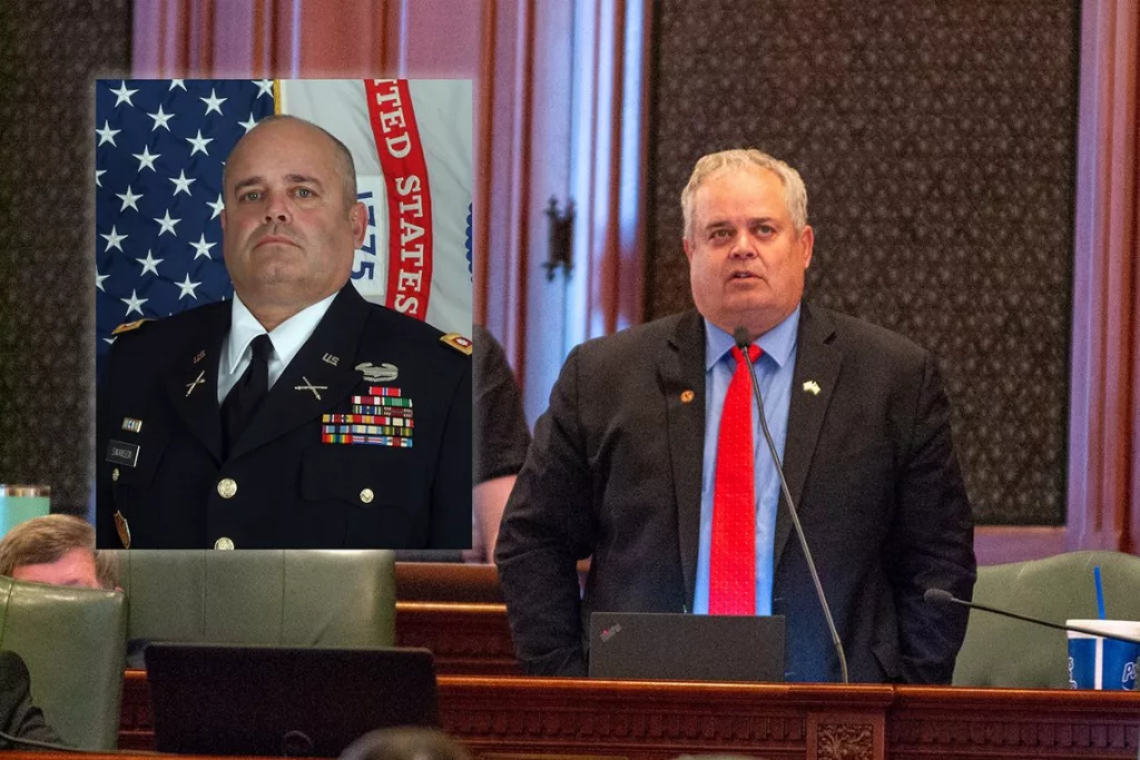 Rep. Dan Swanson, R-Alpha, is pictured on the Illinois House floor alongside a picture of him in military uniform.