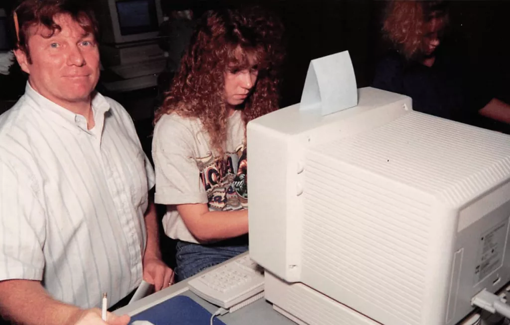 Former Carl Sandburg College math and computer science teacher Larry Schroder works with a student in the 1990s.