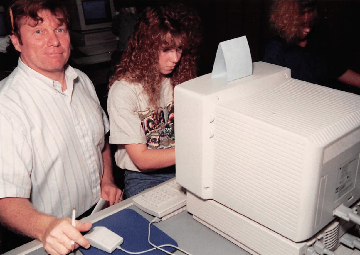 Former Carl Sandburg College math and computer science teacher Larry Schroder works with a student in the 1990s.