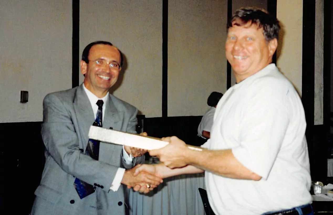 Former Carl Sandburg College math teacher Larry Schroeder receives an award for 20 years of service from President Don Crist on Aug. 18, 1995. 