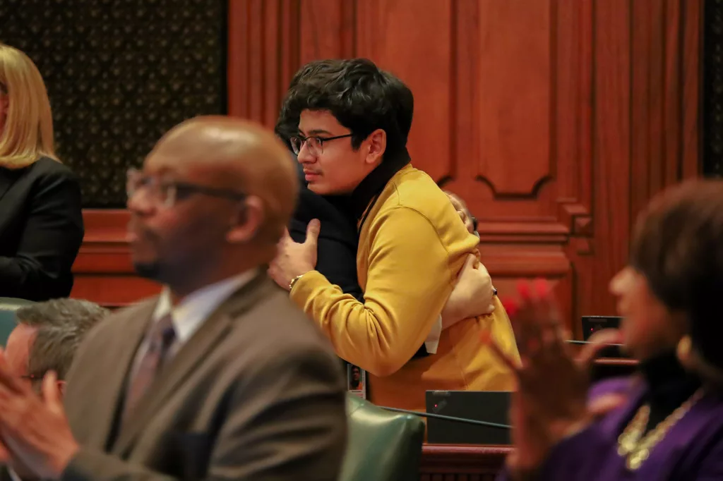 Manny Alvarez, son of Karina Gonzalez, hugs Rep. Edgar Gonzalez Jr., D-Chicago, in the Illinois House on Tuesday, Jan. 7, 2025. Karina Gonzalez, the namesake of the legislation, was allegedly shot and killed by her husband in Chicago in 2023 after receiving an order of protection.