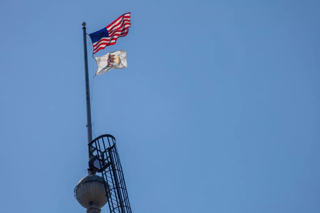 The U.S. and Illinois flags over the state capitol in Springfield in May 2024. 