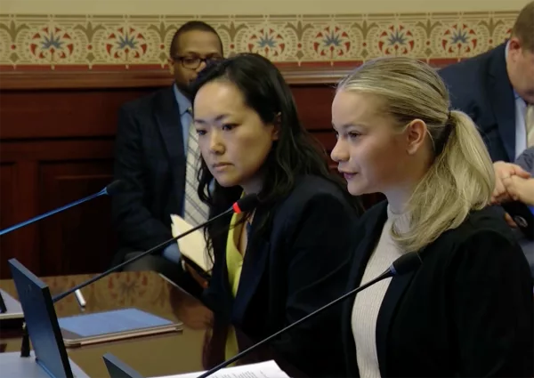 Rep. Janet Yang-Rohr, left, and Carmel Catholic High School student Libby Magnone testify before a House committee on legislation that would let high school student athletes compete on both school-sponsored and nonschool teams in the same sport during the same season. (Capitol News Illinois photo by Peter Hancock)