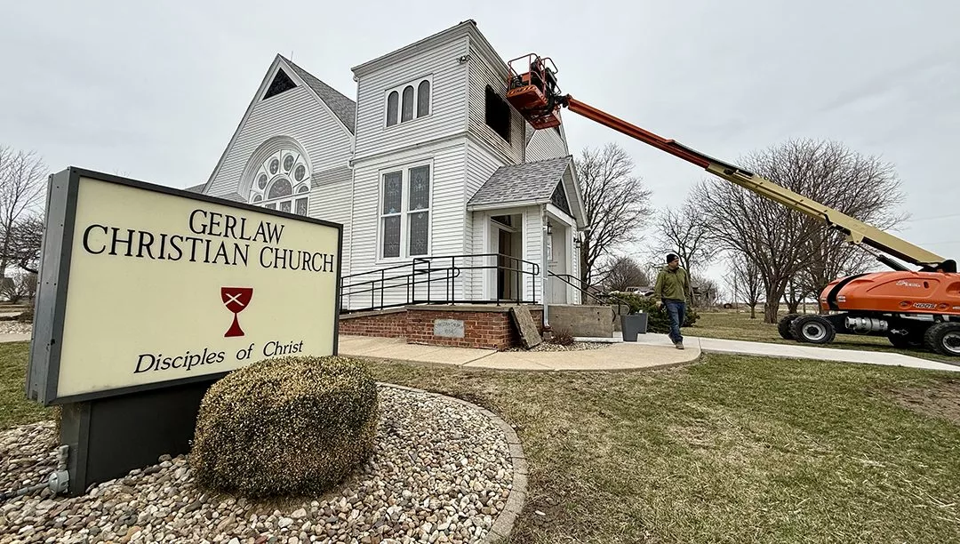 Crews work to secure Gerlaw Christian Church in Warren County on Saturday afternoon. A storm that packed winds between 60 and 80 mph ripped off the steeple of the historic church Friday night.