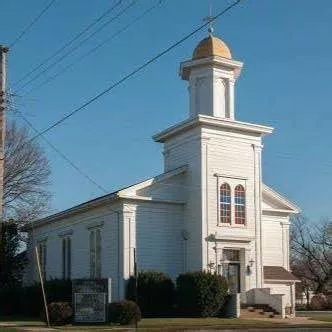 image of white church with blue sky in background