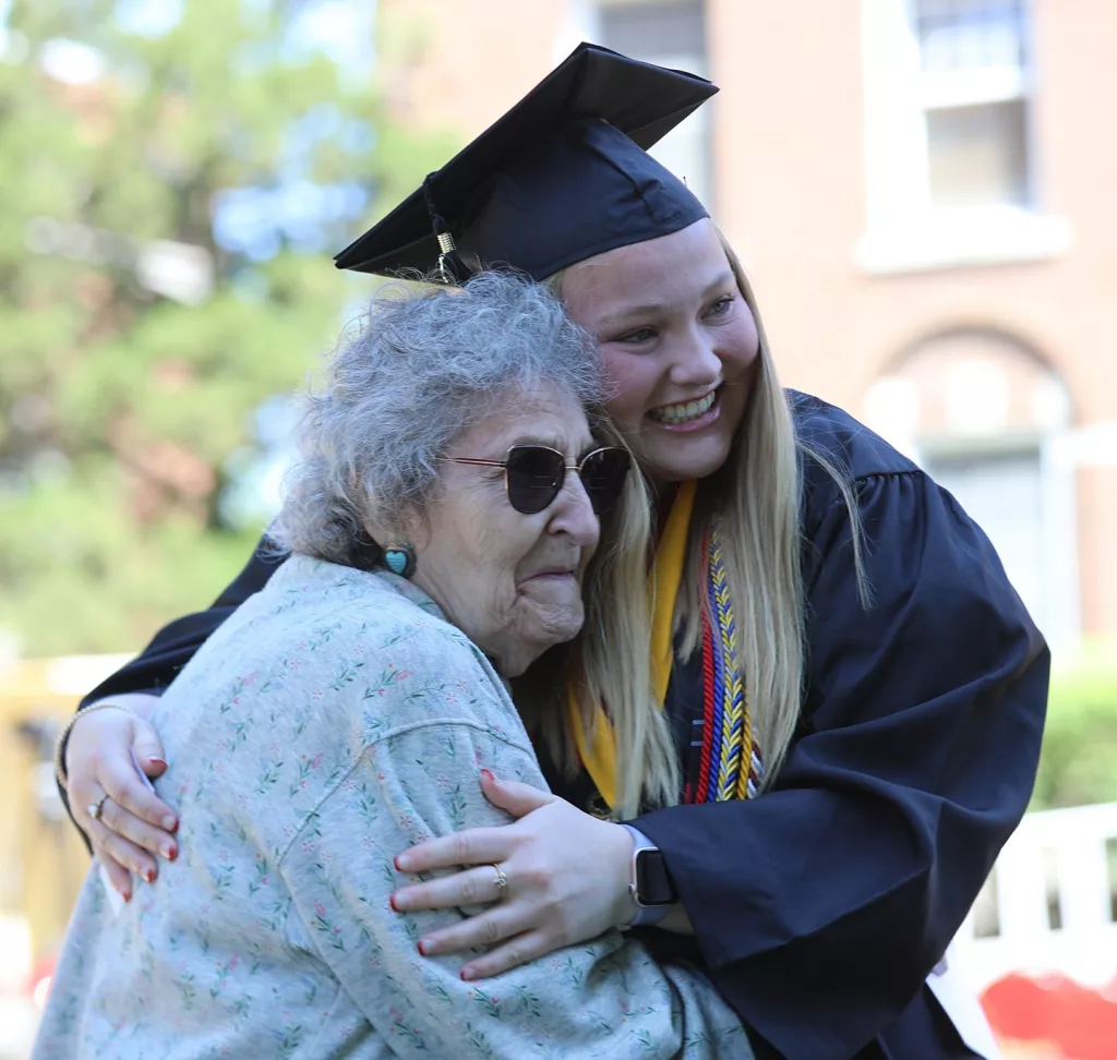 Lea Selquist of Peru, Illinois, is congratulated on her big day. Selquist, who was Monmouth's Lincoln Laureate, addressed her classmates during the Commencement ceremony.