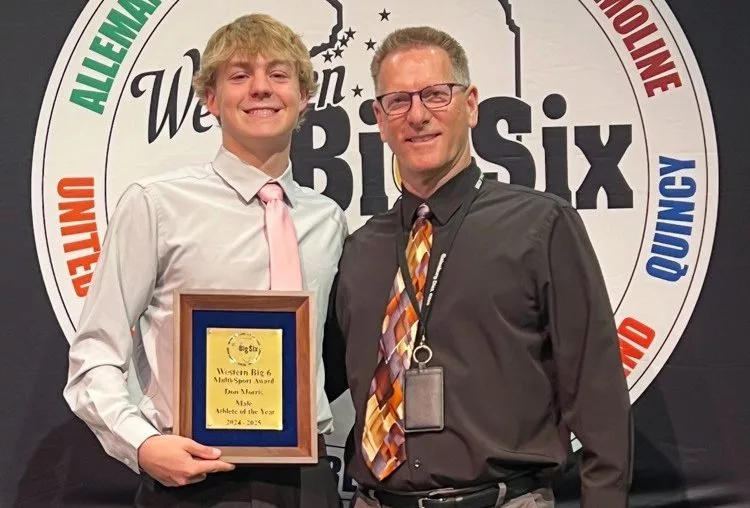 Galesburg High School senior Carson Olson and Streaks swimming coach Ray Van Hootegem.