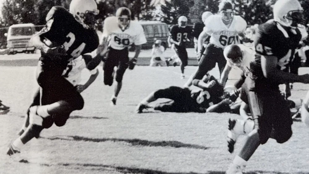 With fullback Jerry Cato leading the way as a blocker, TJ Pendleton carries the ball for the Galesburg Silver Streaks.