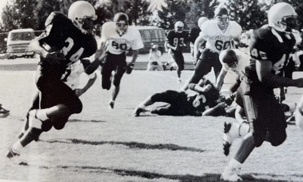 With fullback Jerry Cato leading the way as a blocker, TJ Pendleton carries the ball for the Galesburg Silver Streaks.