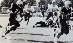 With fullback Jerry Cato leading the way as a blocker, TJ Pendleton carries the ball for the Galesburg Silver Streaks.