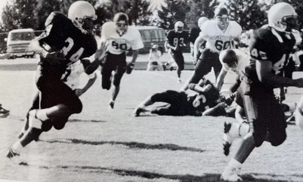 With fullback Jerry Cato leading the way as a blocker, TJ Pendleton carries the ball for the Galesburg Silver Streaks.