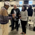 kimbroughs-20: Kellie Kimbrough Mahone, the oldest daughter of the late Albert Kimbrough, talks with guests in attendance at the dedication ceremony for Kimbrough Fieldhouse on Sunday, May 25, 2025. (JAY REDFERN/WGIL)