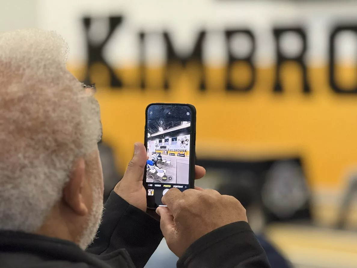 Larry Jackson takes a photo during the dedication ceremony for Kimbrough Fieldhouse on Sunday, May 25, 2025.