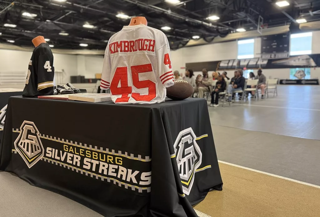 A vibrant mural of Albert and Elbert Kimbrough, frozen in their 1950s football glory, now graces the newly christened Kimbrough Fieldhouse at Galesburg Jr./Sr. High School, unveiled during a heartfelt dedication ceremony on Sunday, May 25, 2025.