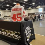 kimbroughs-16: A vibrant mural of Albert and Elbert Kimbrough, frozen in their 1950s football glory, now graces the newly christened Kimbrough Fieldhouse at Galesburg Jr./Sr. High School, unveiled during a heartfelt dedication ceremony on Sunday, May 25, 2025. (JAY REDFERN/WGIL)