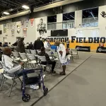 kimbroughs-15: A vibrant mural of Albert and Elbert Kimbrough, frozen in their 1950s football glory, now graces the newly christened Kimbrough Fieldhouse at Galesburg Jr./Sr. High School, unveiled during a heartfelt dedication ceremony on Sunday, May 25, 2025. (JAY REDFERN/WGIL)