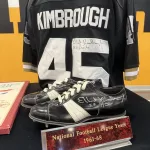 kimbroughs-10: A vibrant mural of Albert and Elbert Kimbrough, frozen in their 1950s football glory, now graces the newly christened Kimbrough Fieldhouse at Galesburg Jr./Sr. High School, unveiled during a heartfelt dedication ceremony on Sunday, May 25, 2025. (JAY REDFERN/WGIL)