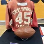 kimbroughs-5: A vibrant mural of Albert and Elbert Kimbrough, frozen in their 1950s football glory, now graces the newly christened Kimbrough Fieldhouse at Galesburg Jr./Sr. High School, unveiled during a heartfelt dedication ceremony on Sunday, May 25, 2025. (JAY REDFERN/WGIL)