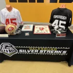 kimbroughs-1: A vibrant mural of Albert and Elbert Kimbrough, frozen in their 1950s football glory, now graces the newly christened Kimbrough Fieldhouse at Galesburg Jr./Sr. High School, unveiled during a heartfelt dedication ceremony on Sunday, May 25, 2025. (JAY REDFERN/WGIL)