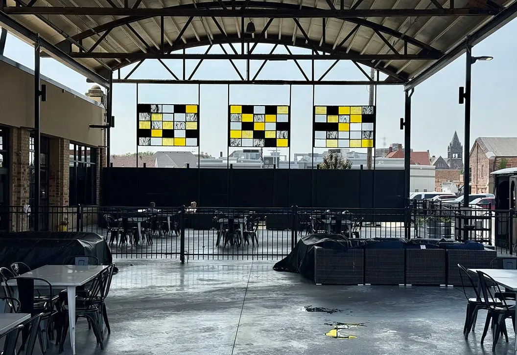 Three stained panels—featuring shades of yellow, gray, and black—were recently installed on the west-facing side of Reserve Artisan Ales, 185 S. Kellogg St. (JAY REDFERN/WGIL)