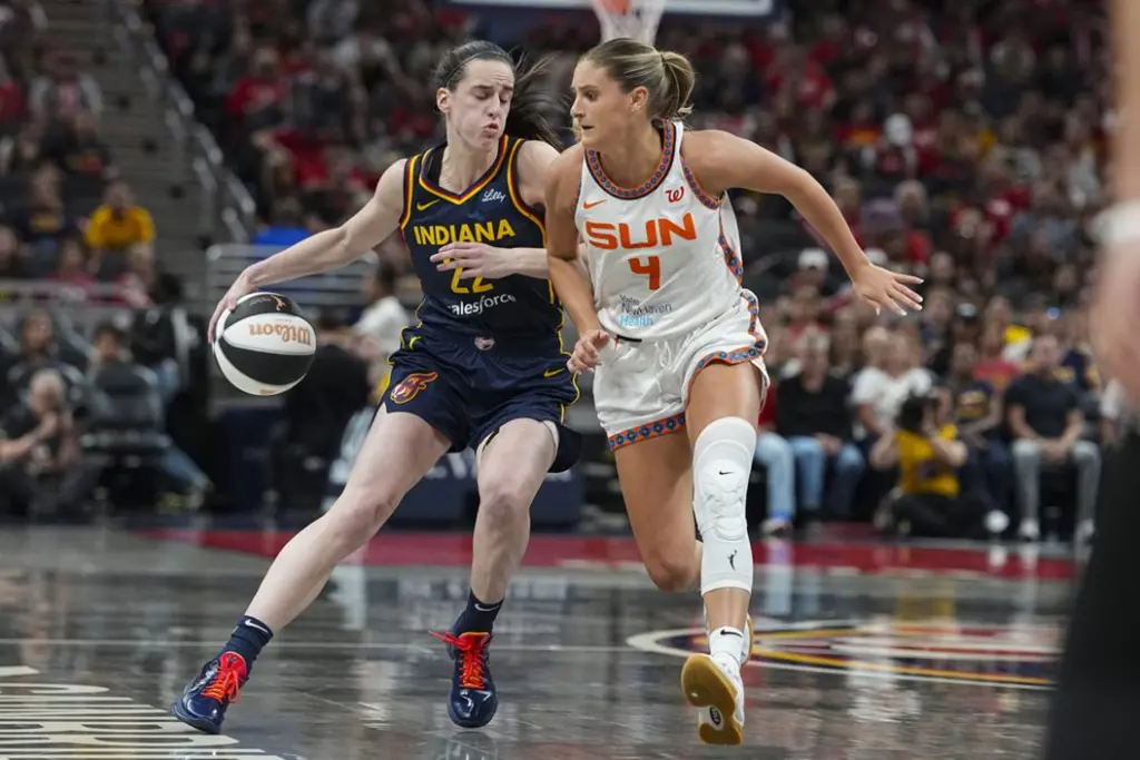 Indiana Fever guard Caitlin Clark (22) drives on Connecticut Sun guard Jacy Sheldon (4) in the second half of a WNBA basketball game in Indianapolis, Tuesday, June 17, 2025.