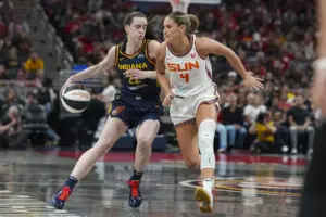 Indiana Fever guard Caitlin Clark (22) drives on Connecticut Sun guard Jacy Sheldon (4) in the second half of a WNBA basketball game in Indianapolis, Tuesday, June 17, 2025.