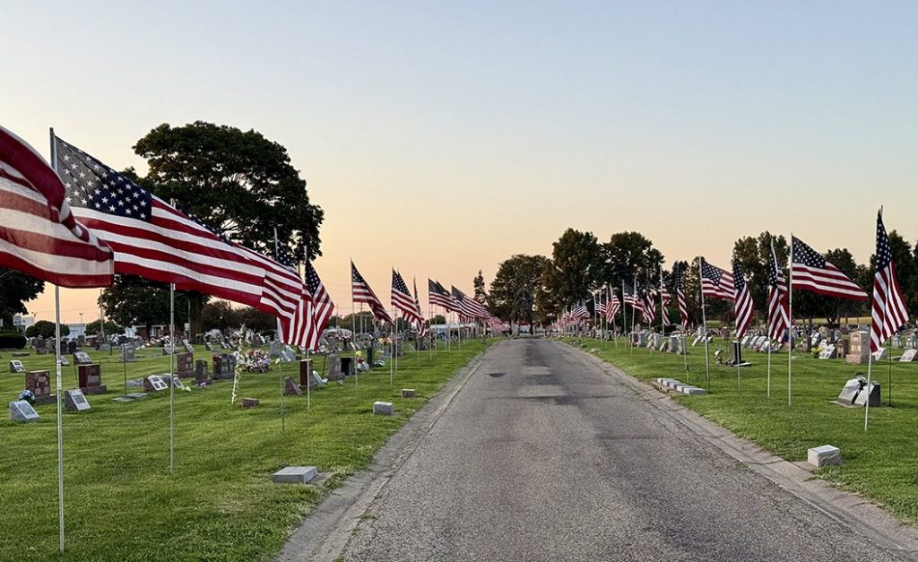 Flags line the route to the grave site of Cpl. Paul Hoots at East Linwood Cemetery in Galesburg.
