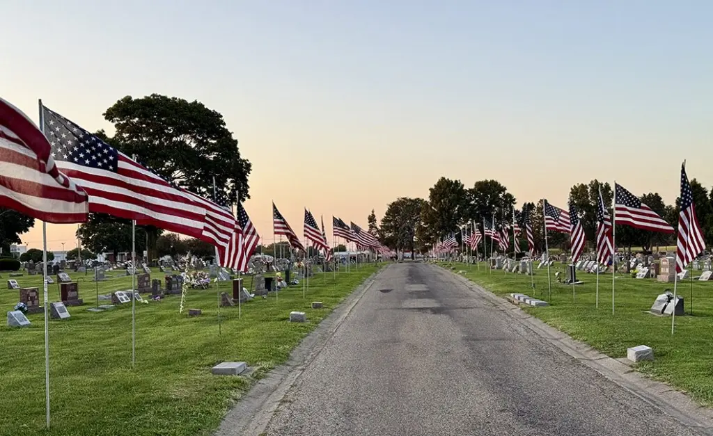 Flags line the route to the grave site of Cpl. Paul Hoots at East Linwood Cemetery in Galesburg.