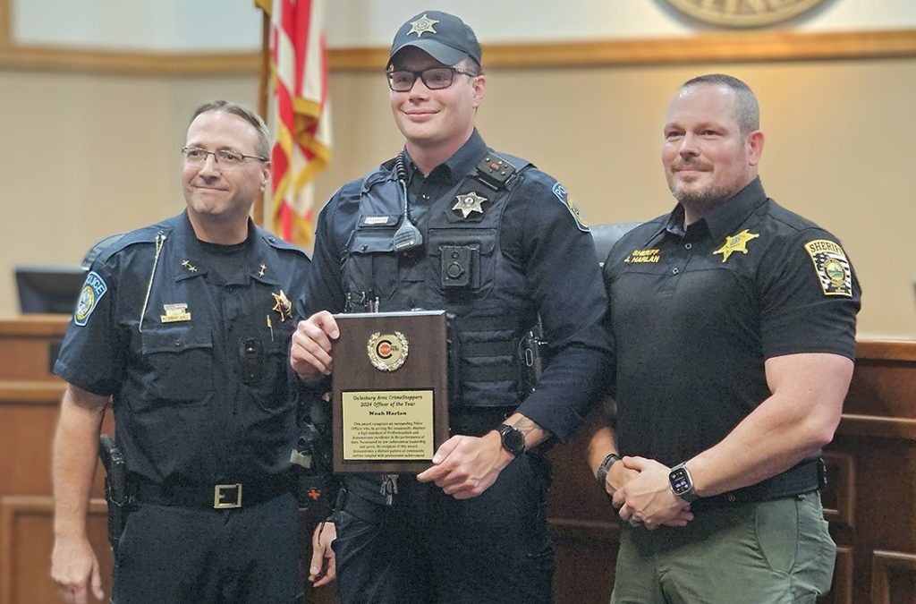 Galesburg Police Officer Noah Harlan, center, is the 2024 Galesburg Area CrimeStoppers Officer of the Year. Also pictured are Galesburg Police Chief Kevin Legate, left, and Knox County Sheriff Jack Harlan. (WGIL)