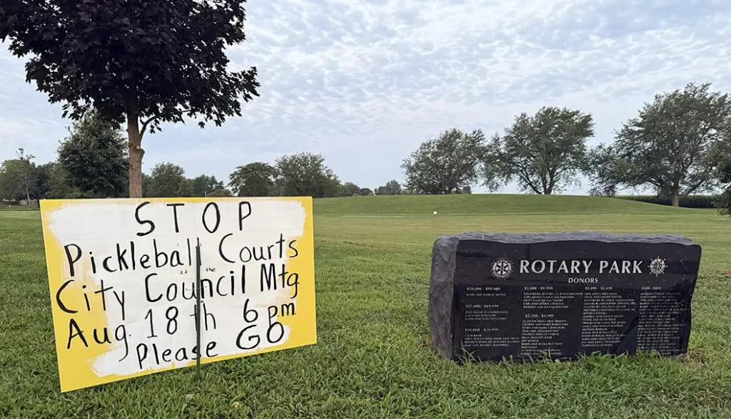 Several signs in opposition of the project could be seen at Rotary Park early Friday morning, saying "Save Our Green Spaces" and "Stop Pickleball Courts" and encouraging attendance at Monday's meeting.