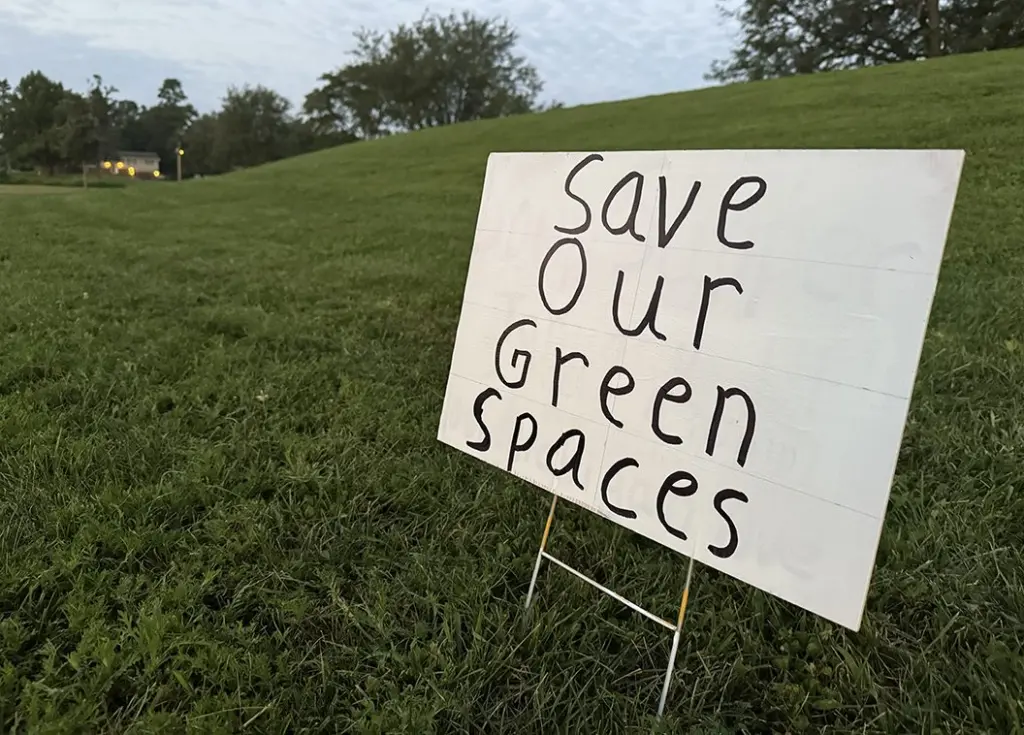 Several signs in opposition of the project could be seen at Rotary Park early Friday morning, saying "Save Our Green Spaces" and "Stop Pickleball Courts" and encouraging attendance at Monday's meeting.