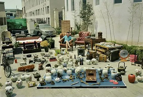 Huang Qingjun’s project, “Family Stuff,” spans more than 20 years and includes 150 photographs. In it, he gathers a family’s belongings from different spaces in their home and arranges them in one place to take a photograph with the family members. (Courtesy of Huang Qingjun)