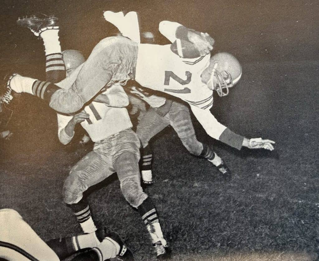 Senior halfback Steve Ferguson carries against Pekin in 1965. 