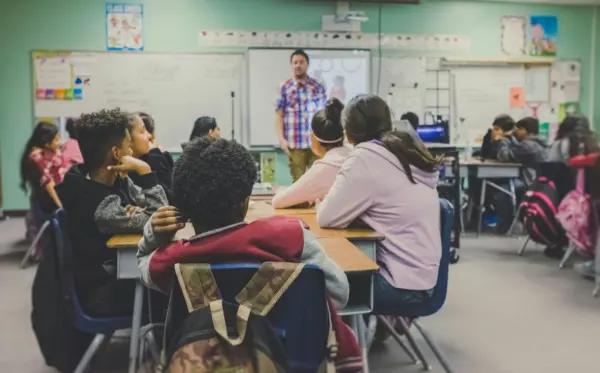 Students sit in a classroom. (Photo by Kenny Eliason, Unsplash)