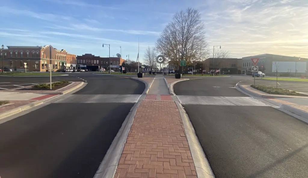 The newly narrowed traffic circle and brick-paved median slow vehicles and welcome pedestrians in Monmouth’s revamped downtown, completed Oct. 27.