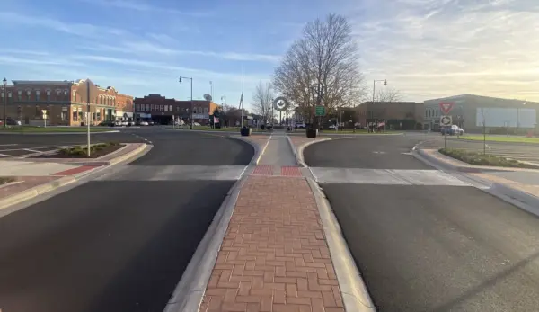 The newly narrowed traffic circle and brick-paved median slow vehicles and welcome pedestrians in Monmouth’s revamped downtown, completed Oct. 27.