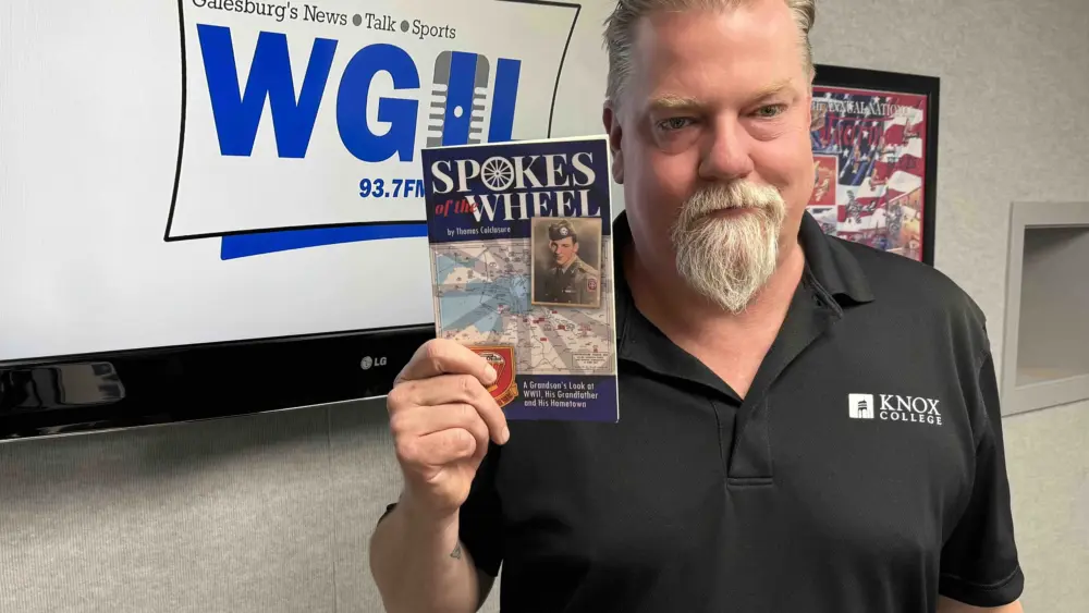 Galesburg author Tom Colclasure in the WGIL studios holding his new book Spokes of the Wheel — the 25-year story of his 82nd Airborne grandfather Henry Raymond Colclasure and the remarkable WWII lives that all connect back to our community. (WGIL)