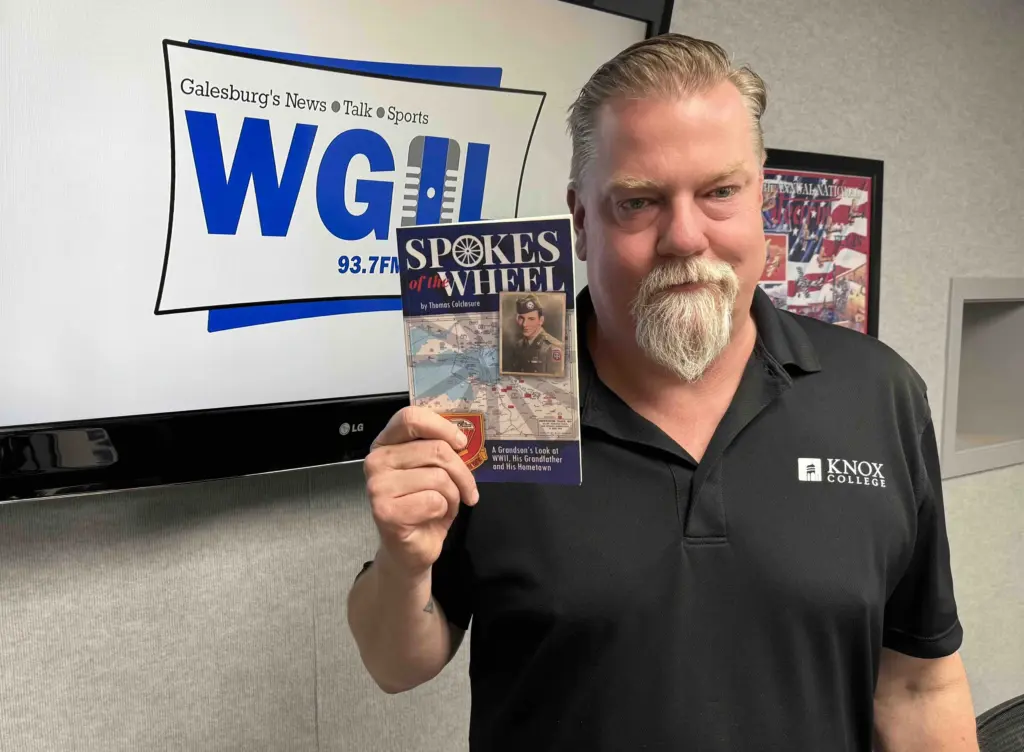 Galesburg author Tom Colclasure in the WGIL studios holding his new book Spokes of the Wheel — the 25-year story of his 82nd Airborne grandfather Henry Raymond Colclasure and the remarkable WWII lives that all connect back to our community. (WGIL)