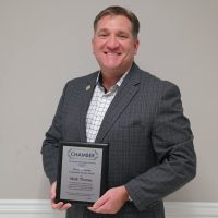 Mark Thomas holds the 2025 Thomas B. Herring Community Service Award plaque after being honored by the Galesburg Area Chamber of Commerce.