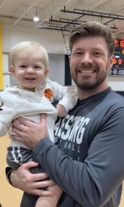 Portrait of Jordan Thomas Ball of Oneida holding his son Atticus.