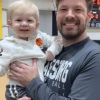 Portrait of Jordan Thomas Ball of Oneida holding his son Atticus.