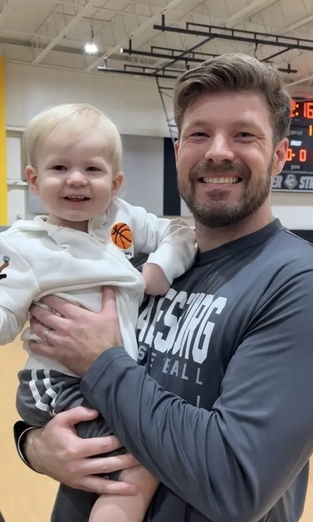 Portrait of Jordan Thomas Ball of Oneida holding his son Atticus.